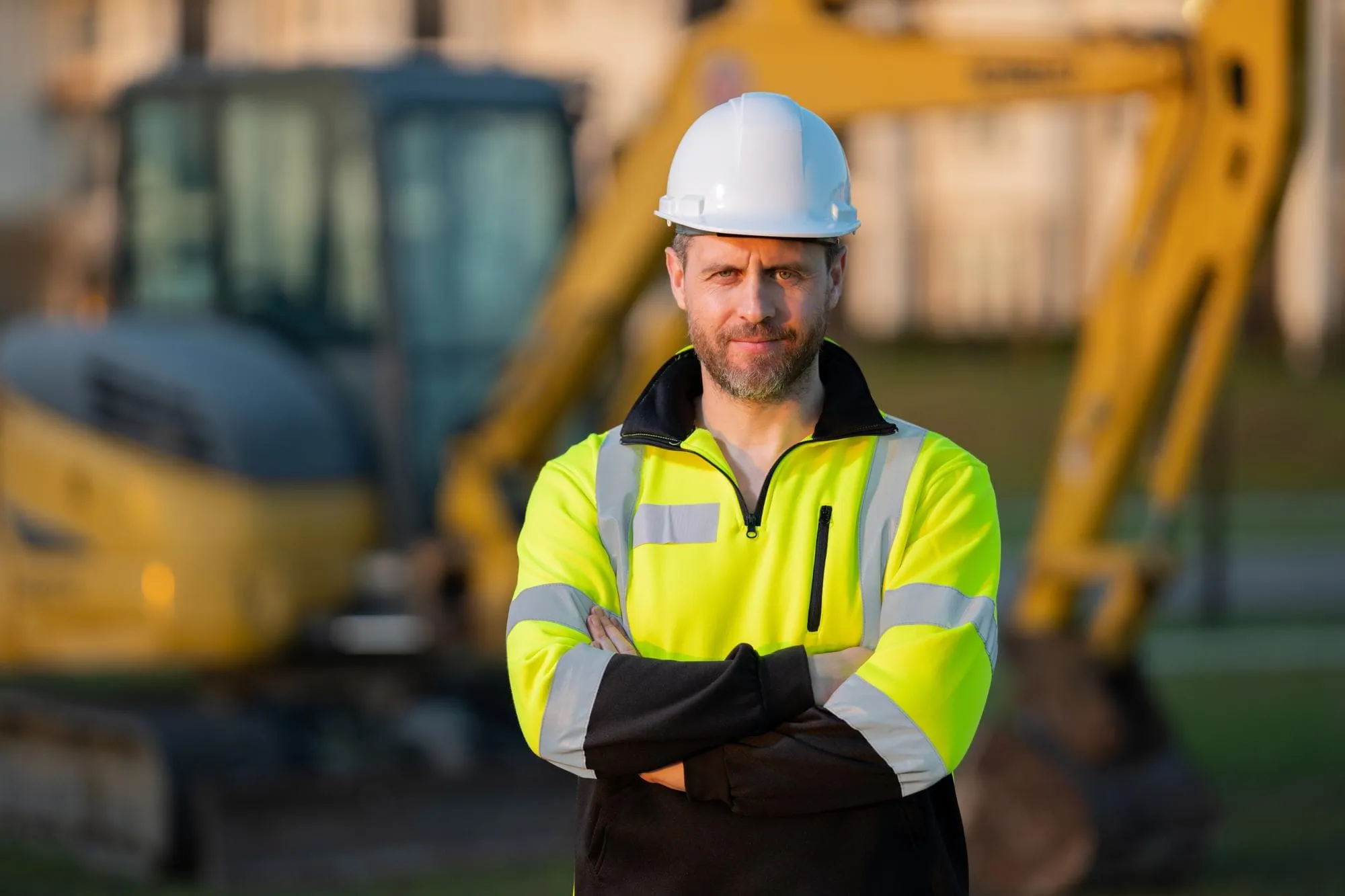 Construction worker operating excavator at Grador Paving job site