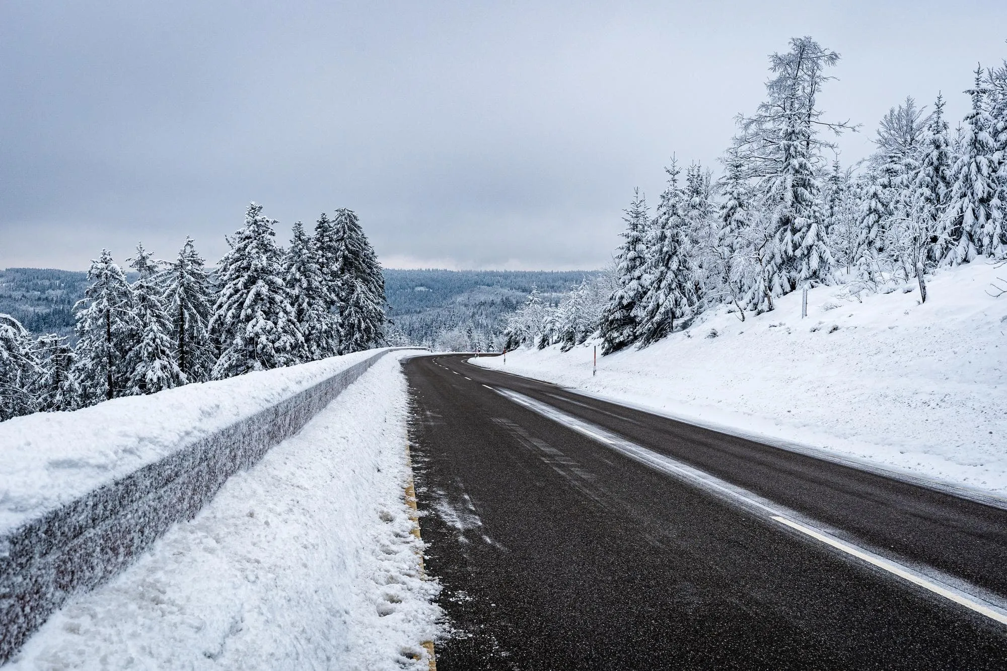 Snow-covered asphalt road in Alberta winter conditions